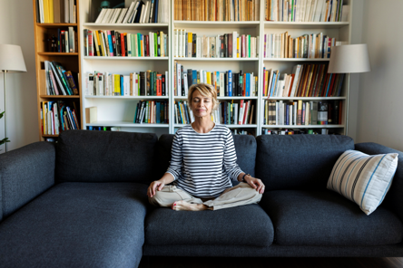 Woman On Couch Meditating At Home